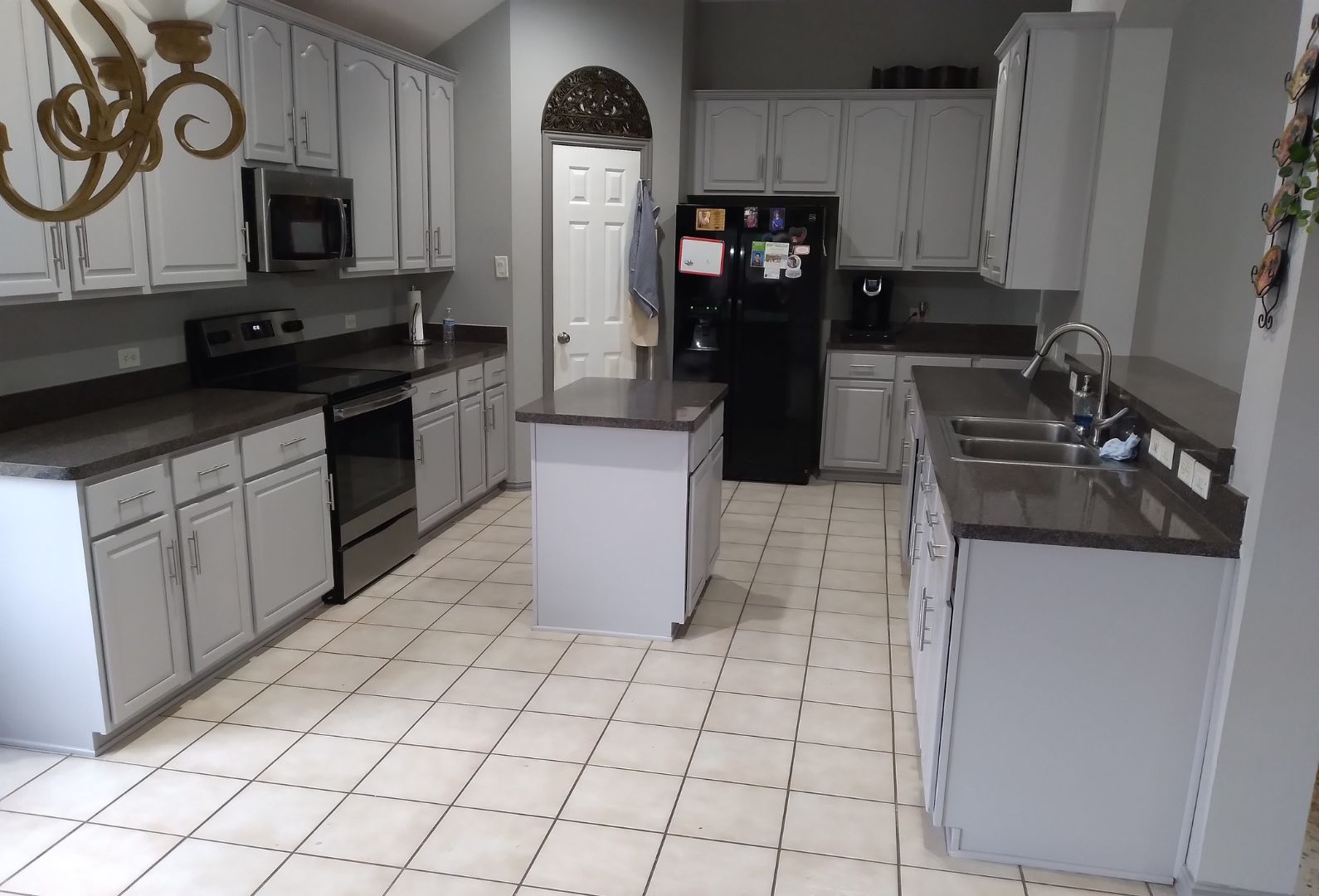 Modern Gray Kitchen by Hard Hat Construction with Sleek Appliances and Ample Counter Space